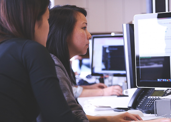Two women look at computer